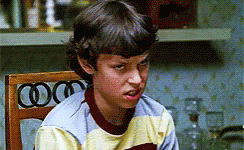 Young Boy Sitting In Chair With Mouth Open GIF