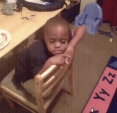 Young Boy Sitting In Wooden Chair Head Resting GIF