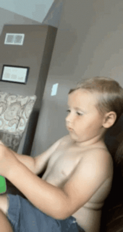 Young Boy Sitting On Couch GIF
