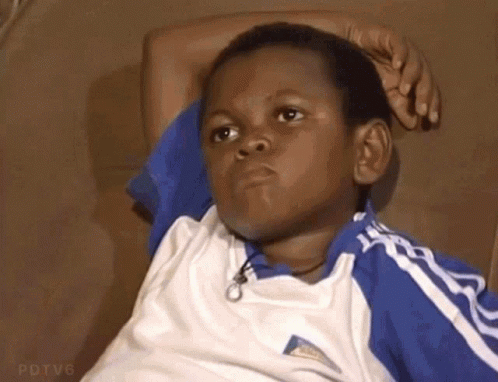 Young Boy Sitting On Couch Hand On Head GIF