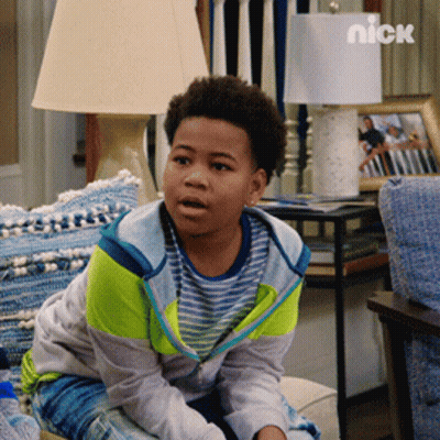 Young Boy Sitting On Couch With Nick Logo GIF