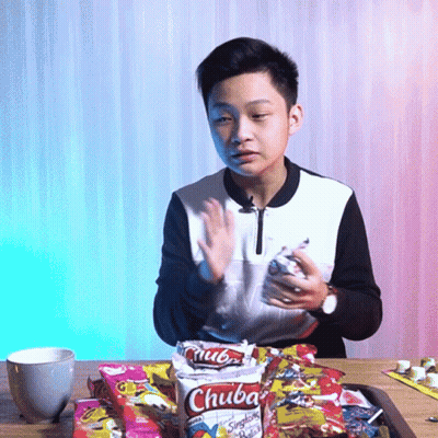 Young Boy Sitting With Bag Of Chuba Chips GIF