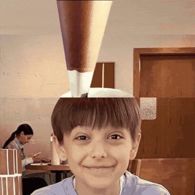 Young Boy Smiling In Front Of Woman At Table GIF