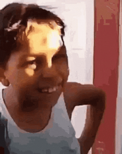 Young Boy Smiling With Sticker On Head GIF