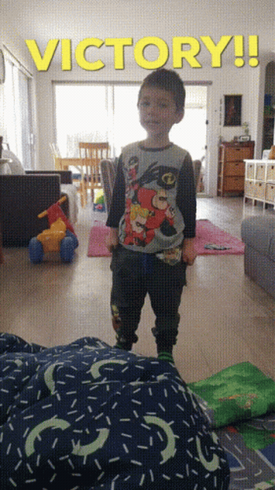 Young Boy Standing Under Victory Sign GIF
