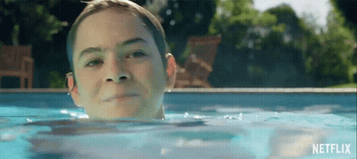 Young Boy Swimming In Pool With Netflix Logo GIF