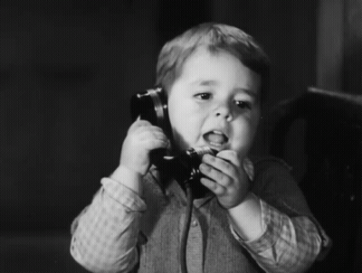 Young Boy Talking On Telephone GIF