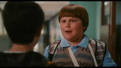 Young Boy Talking To Another Boy In Hallway GIF