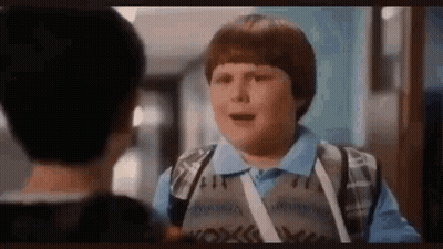 Young Boy Talking To Another Boy In Hallway GIF