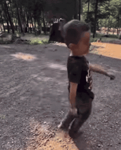 Young Boy Walking On Dirt Road GIF