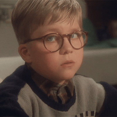 Young Boy Wearing Glasses And Sweater Saying A GIF