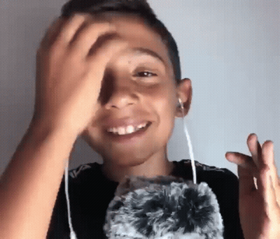 Young Boy Wearing Headphones Holding Stuffed Animal GIF