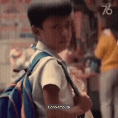 Young Boy With Backpack In Crowd GIF