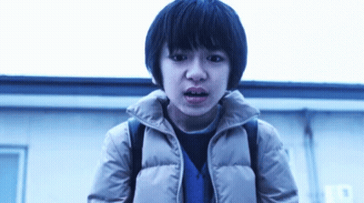 Young Boy With Backpack Standing In Front Of Building GIF