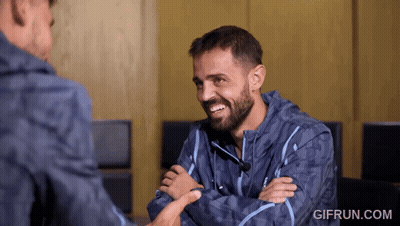 Young Boy With Backpack Talking To Another Boy In Hallway GIF