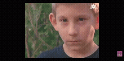 Young Boy With Bandage On Head Looking At Camera GIF