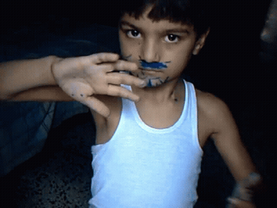 Young Boy With Blue Paint On Face In Tank Top GIF