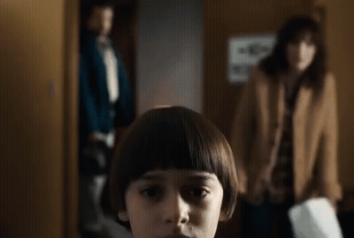 Young Boy With Bob Hairstyle In Front Of Woman And Man GIF
