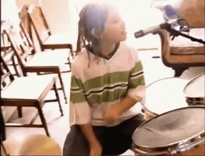 Young Boy With Dreadlocks Playing Drums GIF