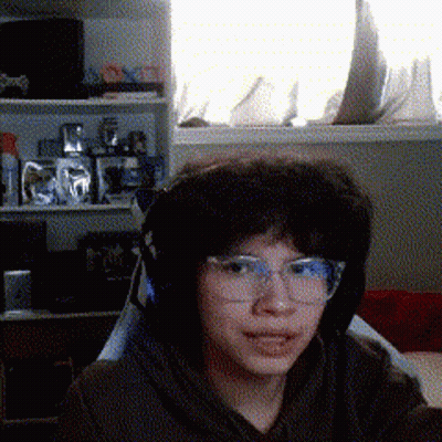 Young Boy With Glasses And Headphones By Window GIF