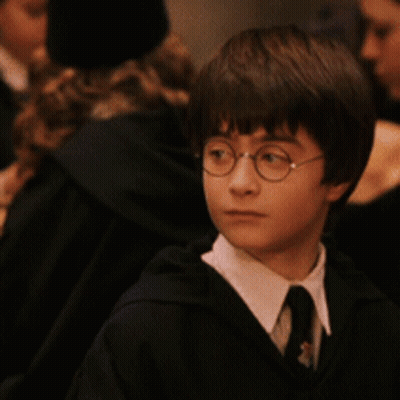 Young Boy With Glasses And Tie Looking At Camera GIF