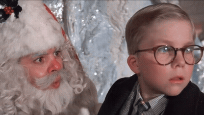 Young Boy With Glasses Next To Santa Claus GIF