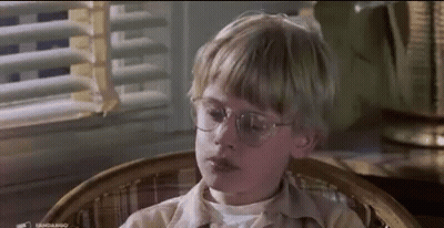Young Boy With Glasses Sitting By Window GIF
