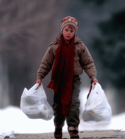 Young Boy With Hat And Scarf Carrying Two Bags GIF