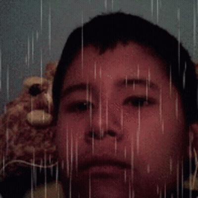 Young Boy With Teddy Bear In Rain GIF