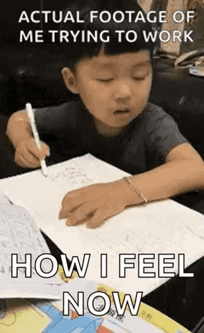 Young Boy Writing In Notebook At Table GIF