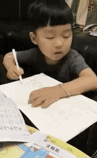 Young Boy Writing In Notebook GIF