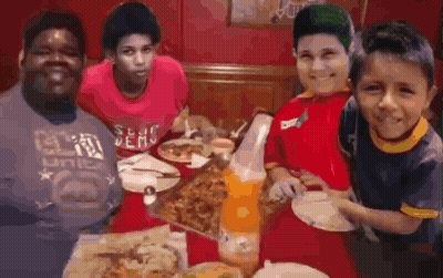 Young Boys Eating Pizza Around Table GIF