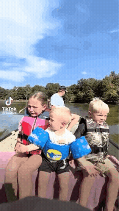 Young Children In Boat On Lake GIF
