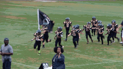 Young Football Players In Black And Gold Uniforms Number 27 GIF