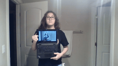 Young Girl Holding Laptop With Woman On Screen GIF