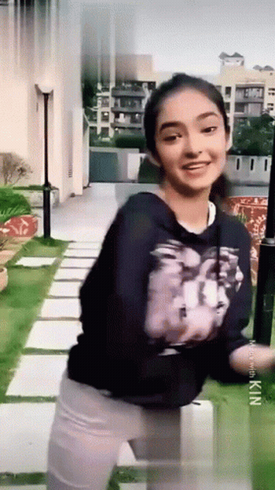 Young Girl In Black Sweatshirt And White Pants GIF