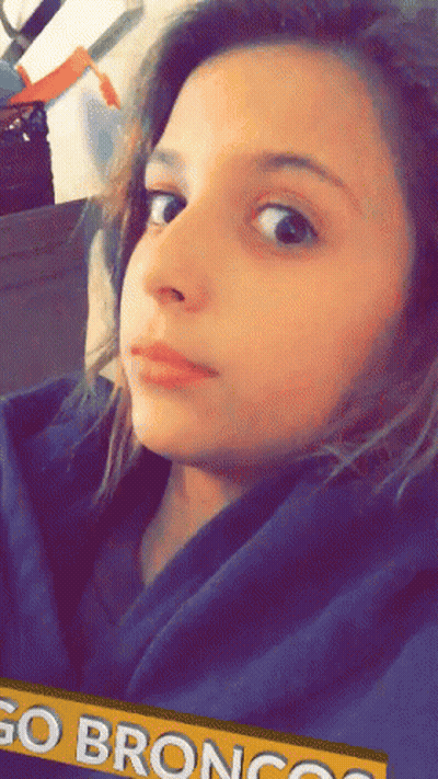 Young Girl In Blue Hoodie With Go Broncos Banner GIF