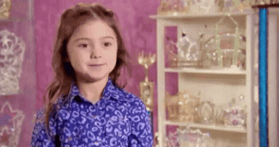 Young Girl In Blue Shirt With Trophies GIF
