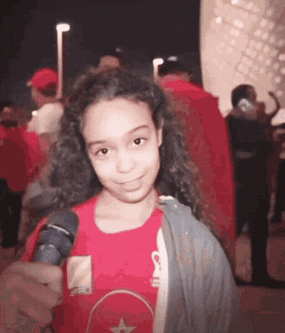 Young Girl In Red Shirt Holding Microphone GIF