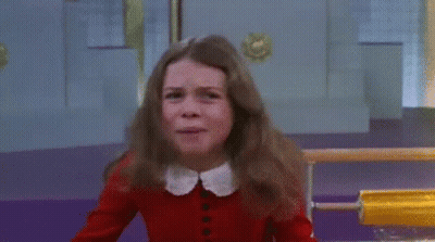 Young Girl In Red Sweater Crying In Front Of Yellow Object GIF