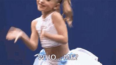 Young Girl In White Crop Top And Blue Skirt Dancing Saying Who Me GIF