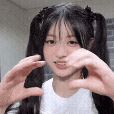 Young Girl Making Heart Shape With Hands