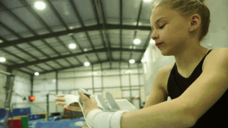 Young Girl Putting Chalk On Her Hand GIF
