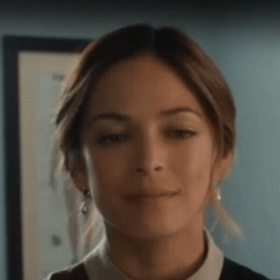 Young Girl Sitting On Couch With Legs Crossed GIF