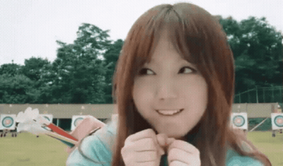 Young Girl Smiling Holding Bow And Arrow GIF