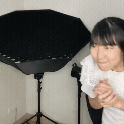 Young Girl Standing In Front Of Black Umbrella GIF