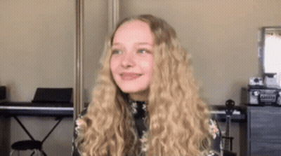Young Girl With Blonde Hair In Front Of Piano GIF
