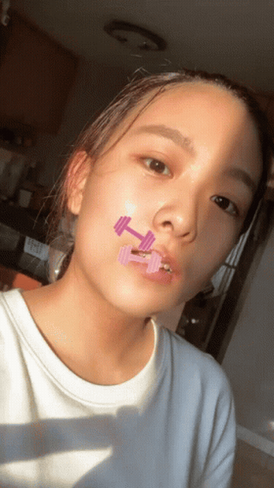 Young Girl With Dumbbell On Face GIF