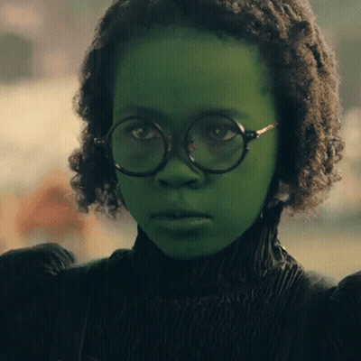 Young Girl With Green Paint And Round Glasses GIF