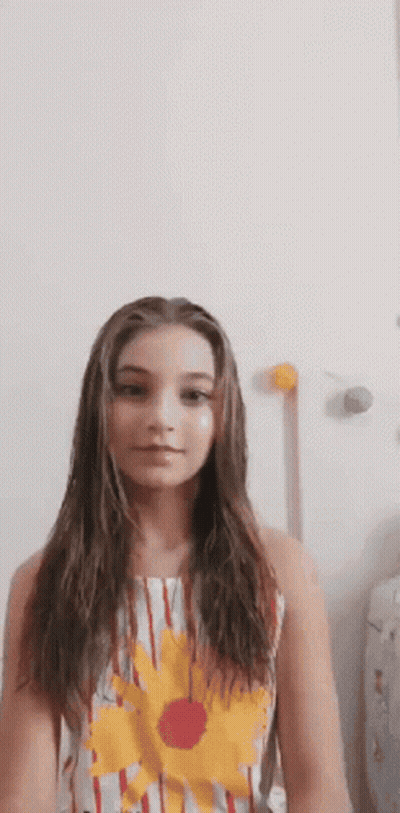 Young Girl With Long Hair In Striped Dress And Flower GIF